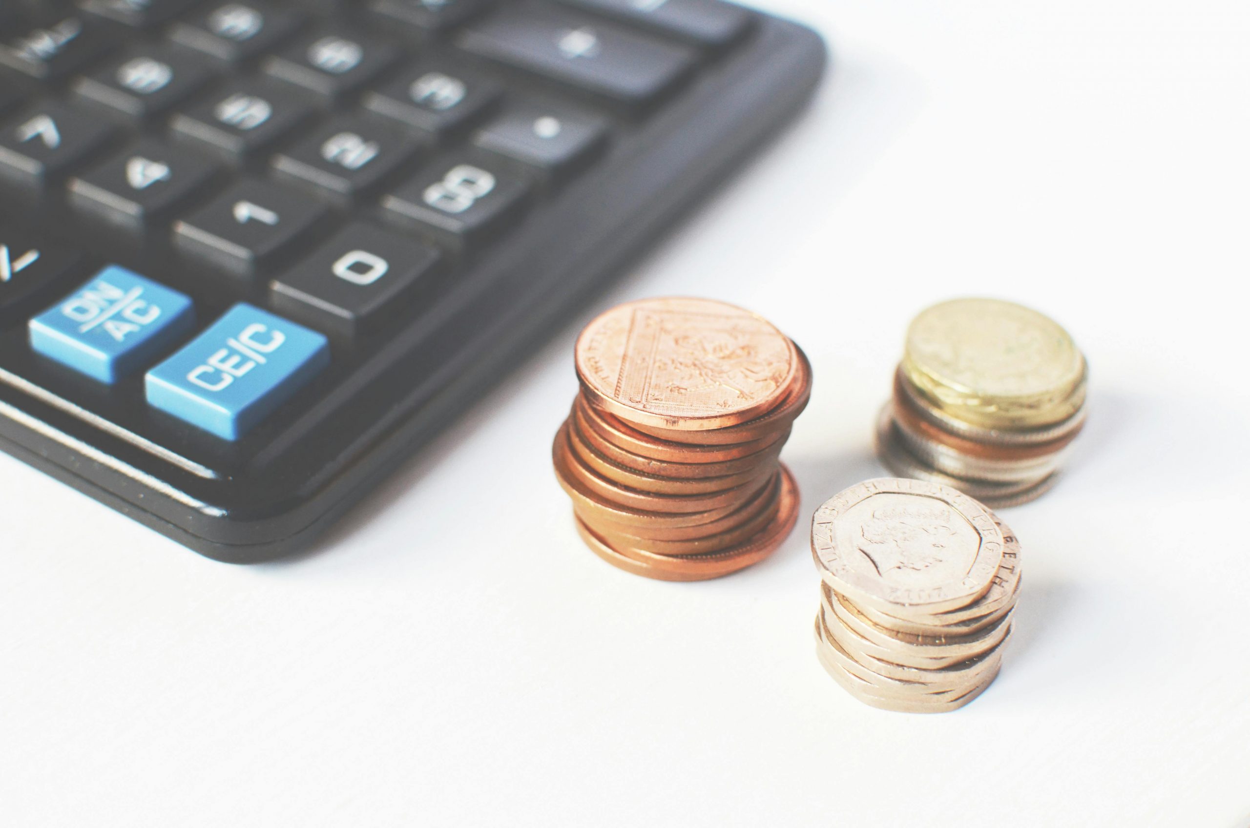 stacked coins and a calculator